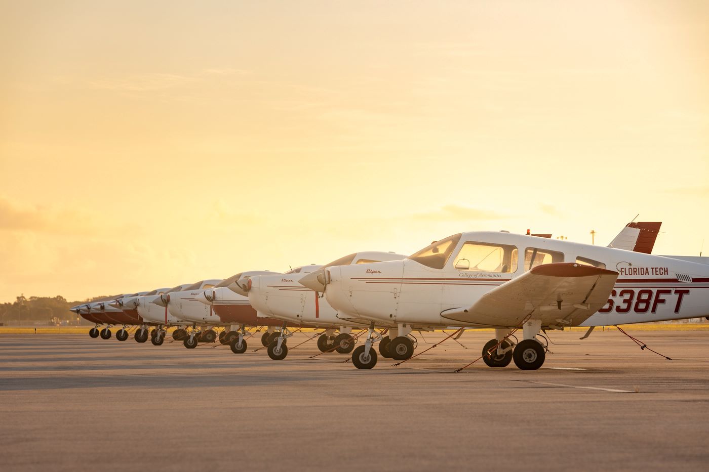 Runway with airplanes in line.